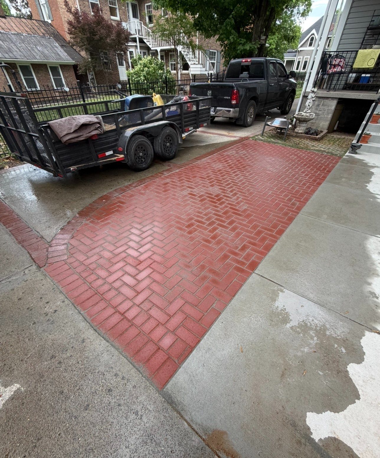 Red brick paver driveway apron with herringbone pattern