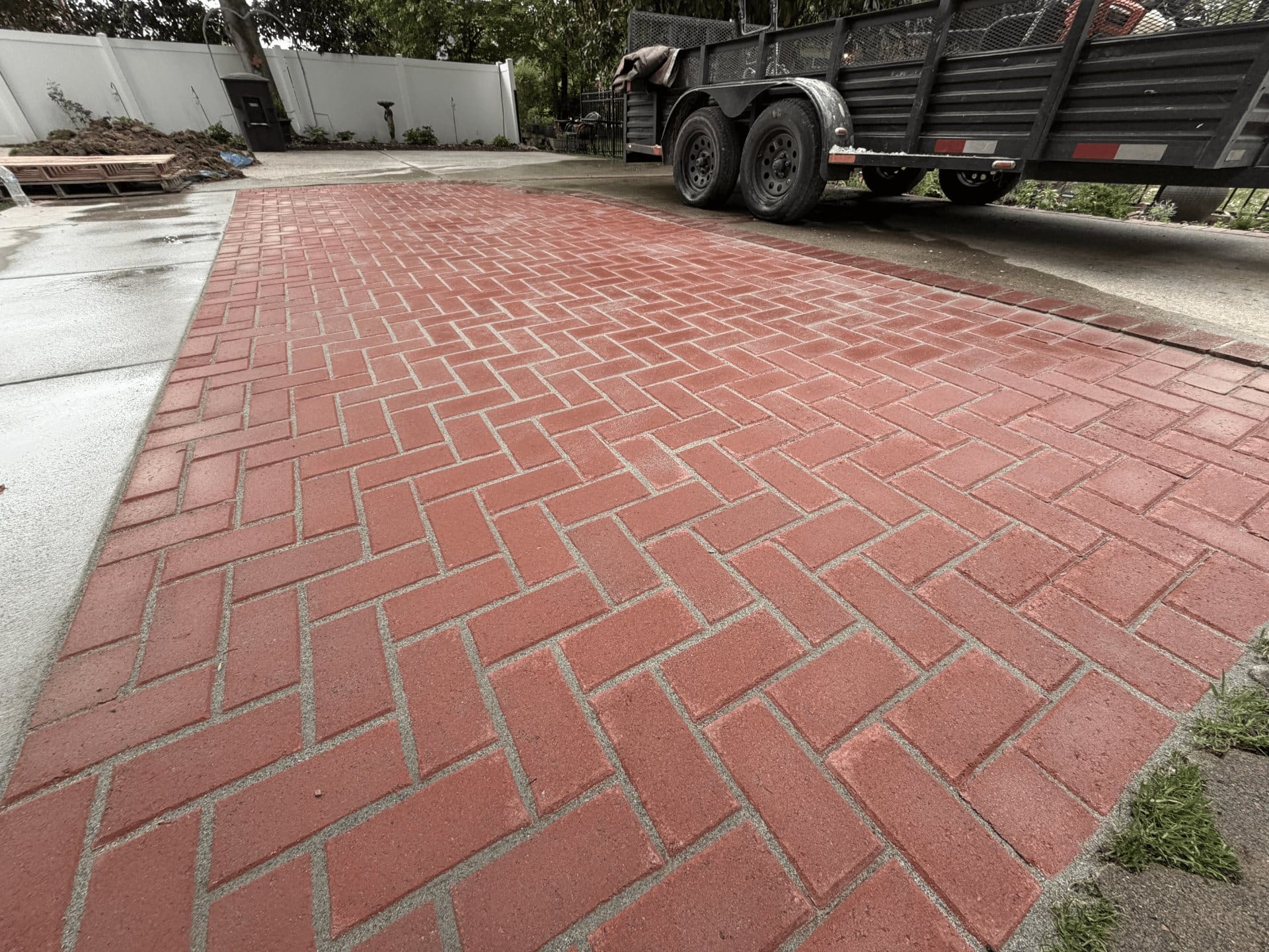 Close view of a red herringbone brick driveway