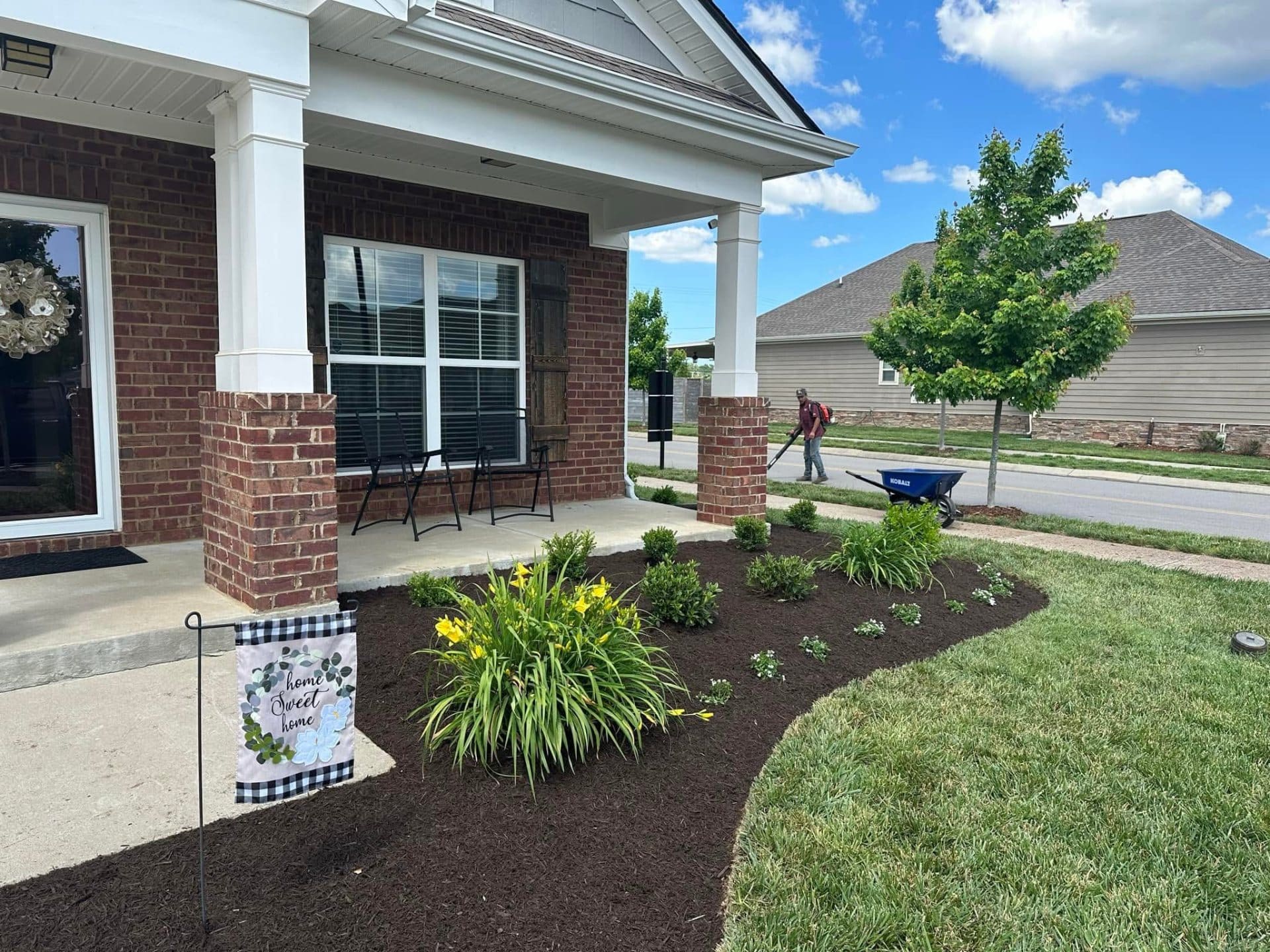 Fresh plantings along a covered porch