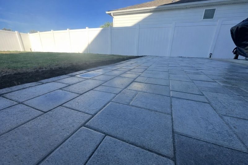 Large paver patio installed beside a home