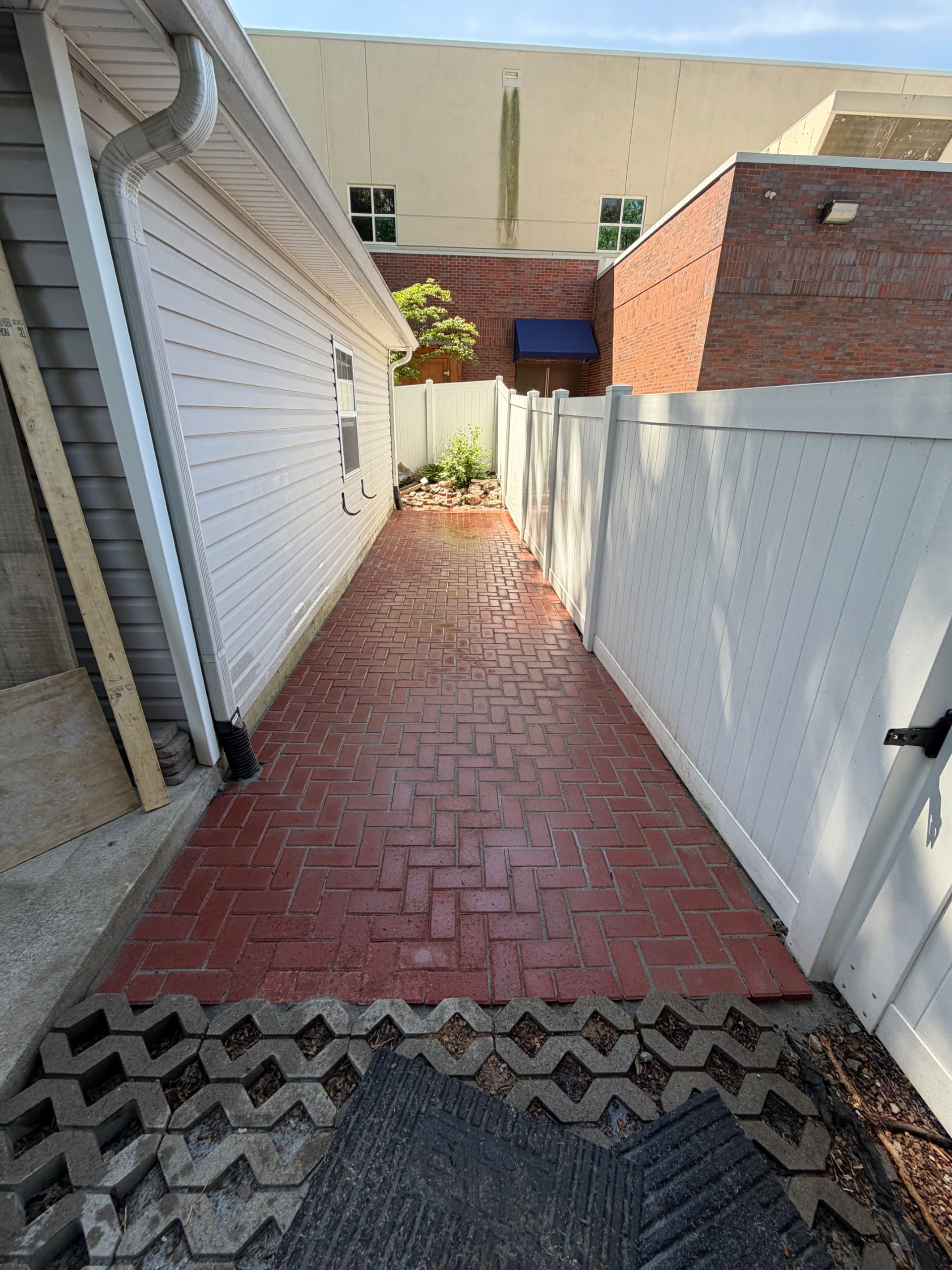 Side yard walkway with downspout runoff channel