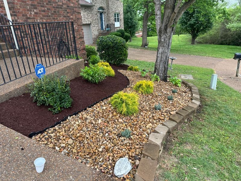 Decorative river rock bed with stone border